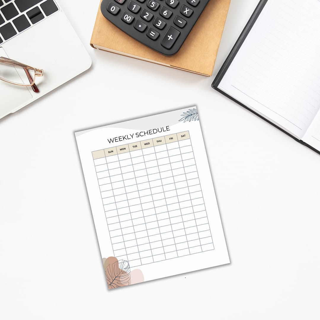 A productivity boost unfolds on the desk, showcasing the Productivity Planner Templates nestled among a laptop, calculator, notebook, and glasses.