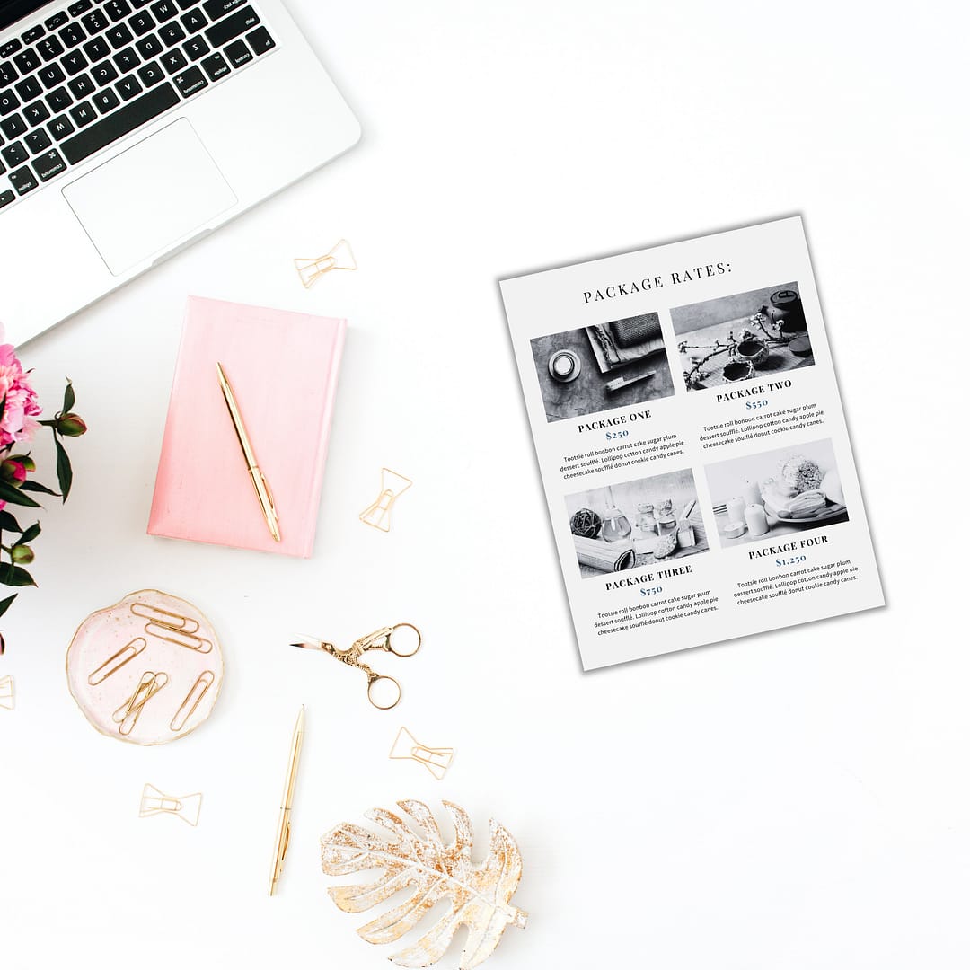 A neatly organized workspace features a laptop, pink notebook, pen, paper clips, scissors, a decorative leaf, flowers, and the Services and Pricing Guide showcasing four service packages.