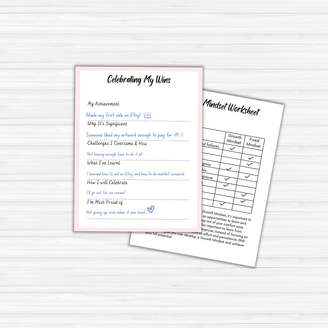 On a light wood surface, two "The Glow Getter" worksheets are displayed. On the left, a "Celebrating My Wins" worksheet highlights handwritten achievements that embody the spirit of a true glow getter. On the right, a "Mindset Worksheet" features a grid comparing fixed and growth mindsets, ideal for anyone excelling in their personal development journey.